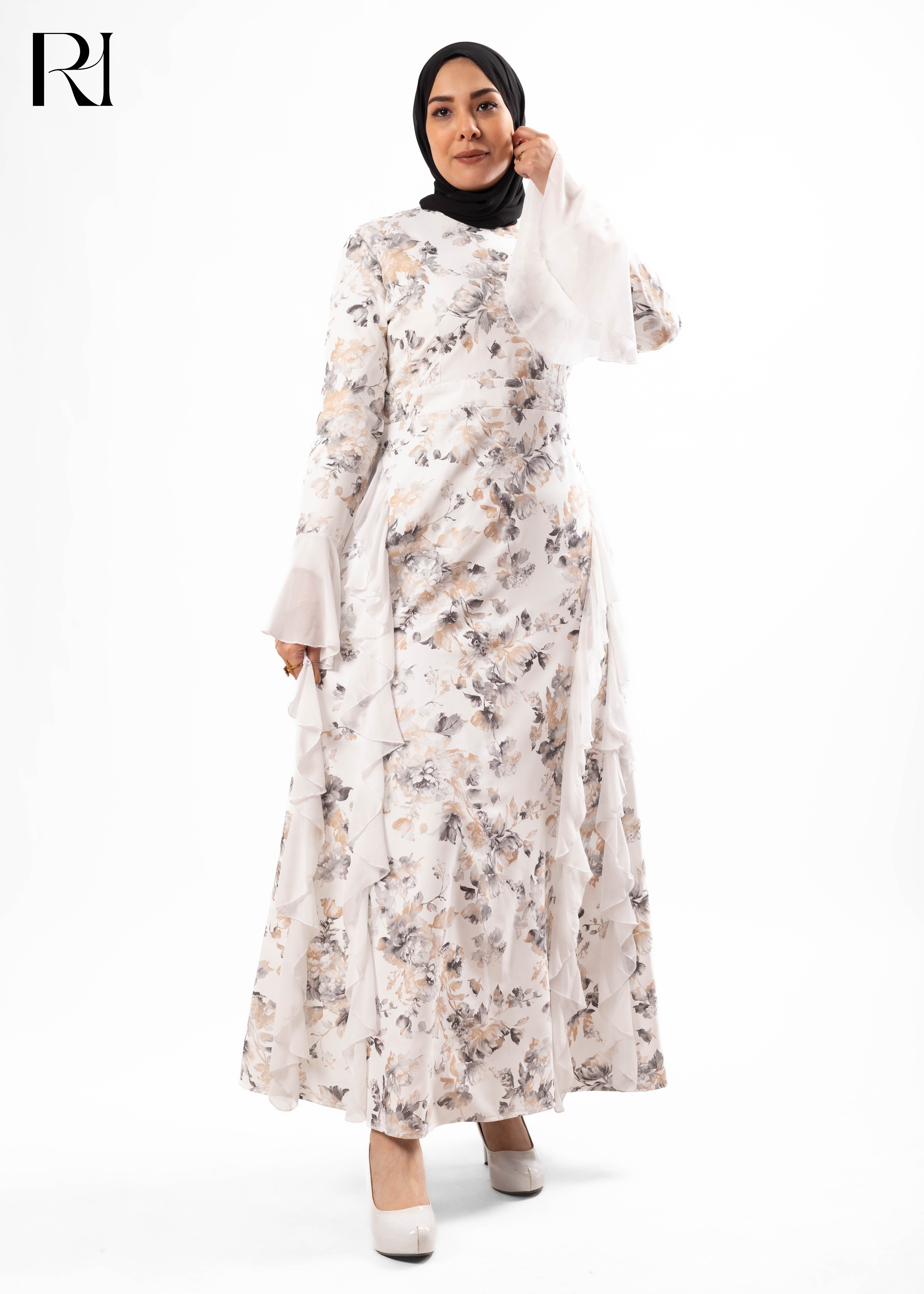 Woman wearing a floral dress with a hijab on a white background