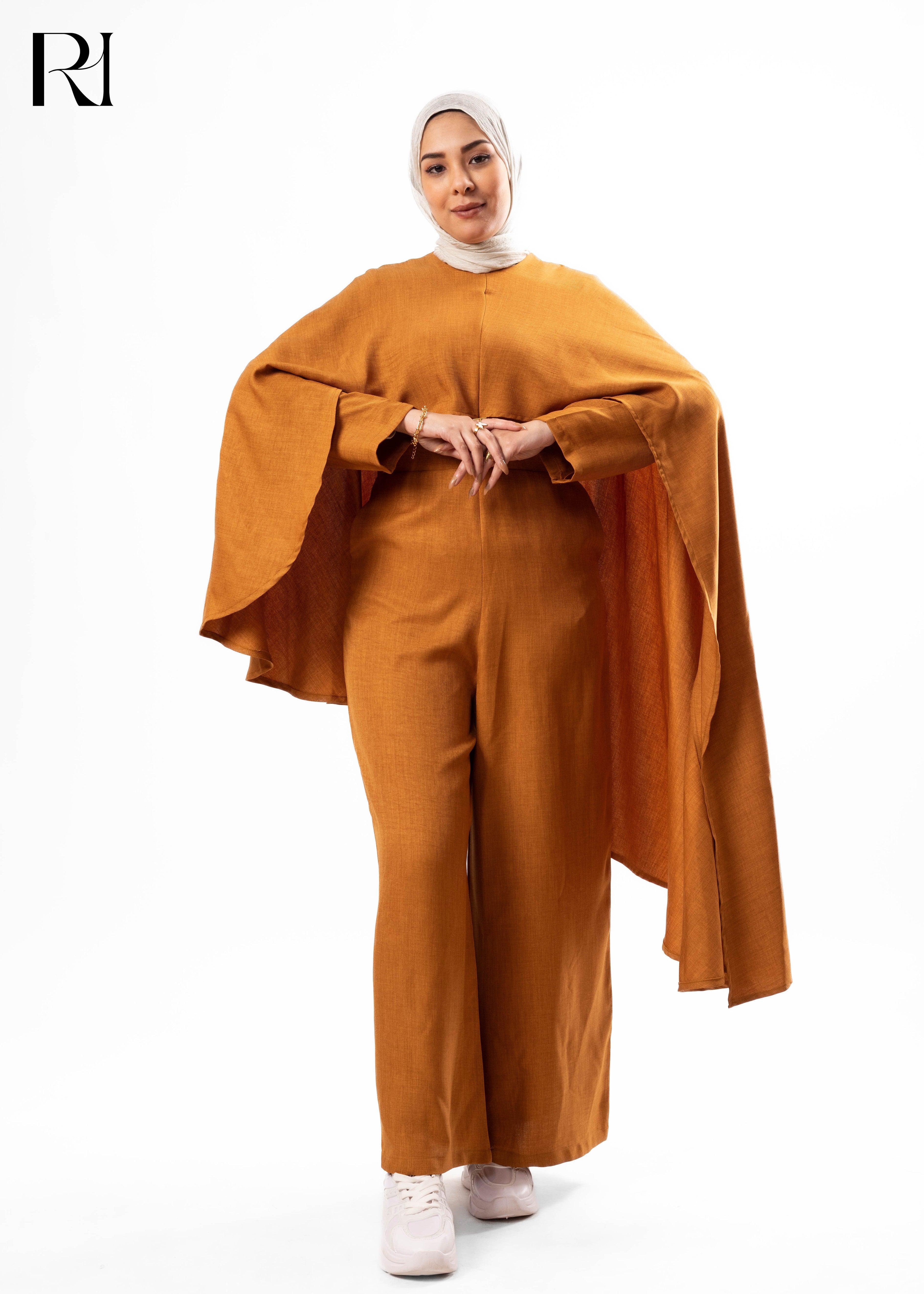 Person wearing a mustard yellow outfit with a hijab on a white background