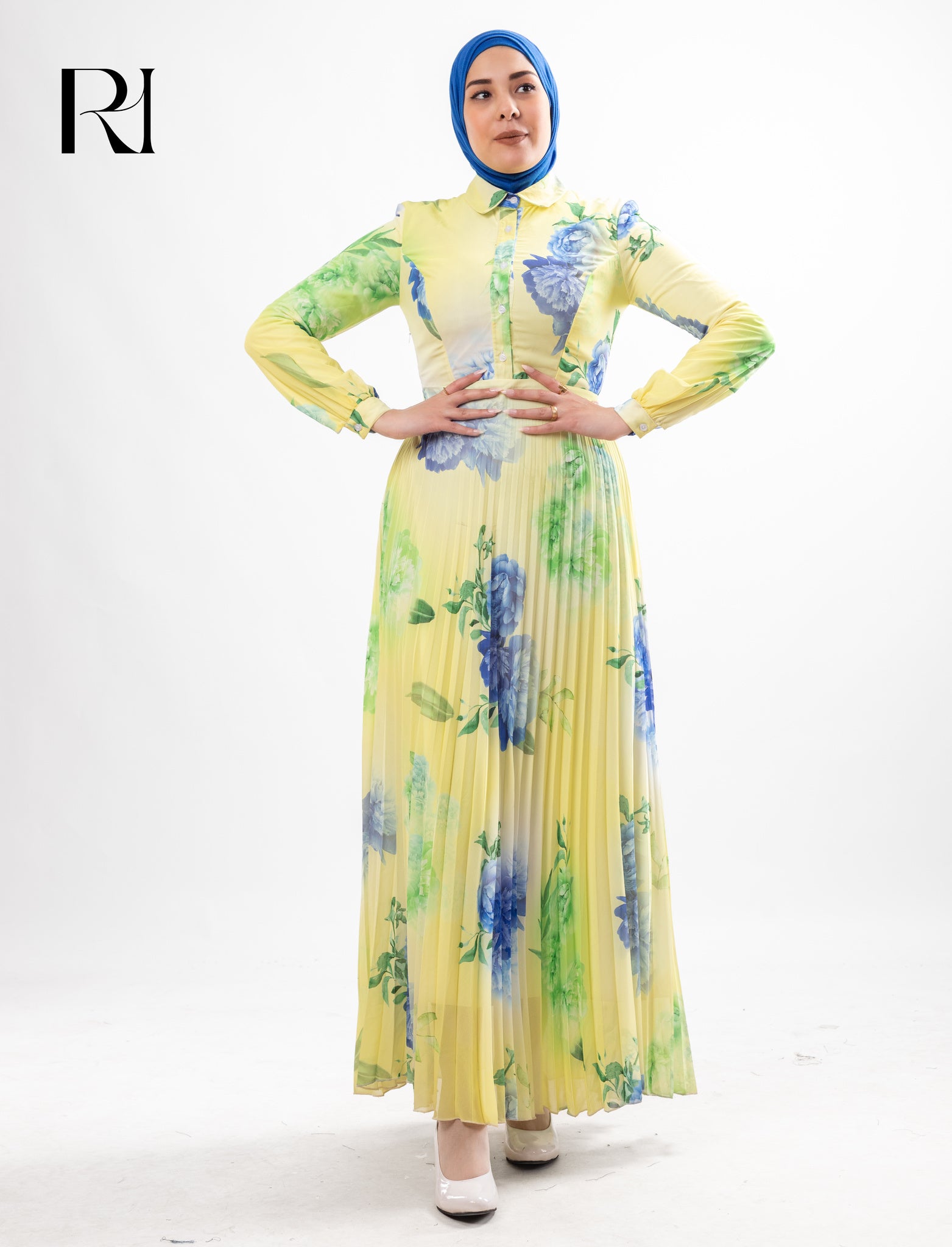 Woman wearing a yellow floral dress with a blue hijab on a white background