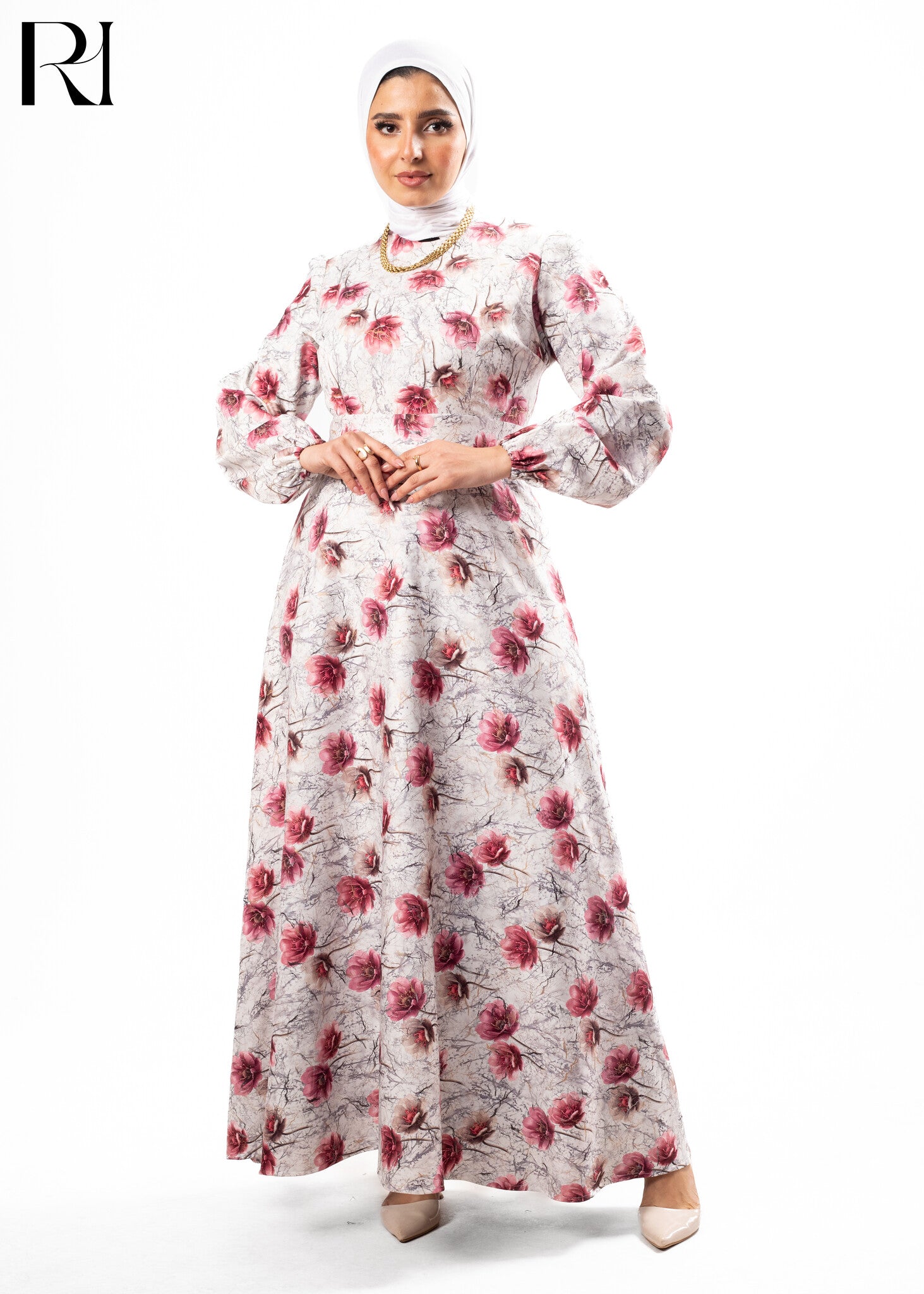 Woman wearing a floral dress with a hijab on a white background
