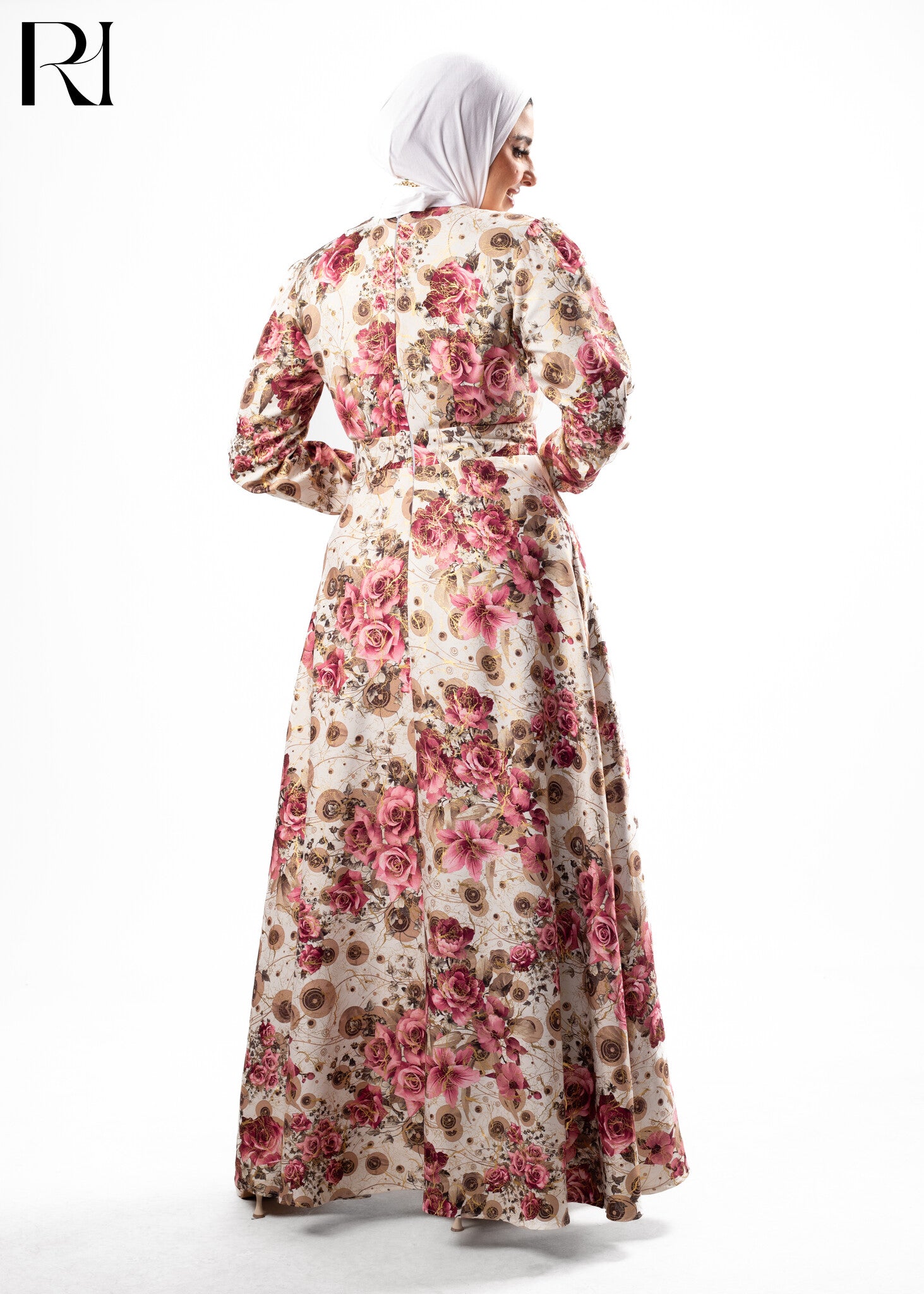 Woman wearing a floral dress with a hijab on a white background