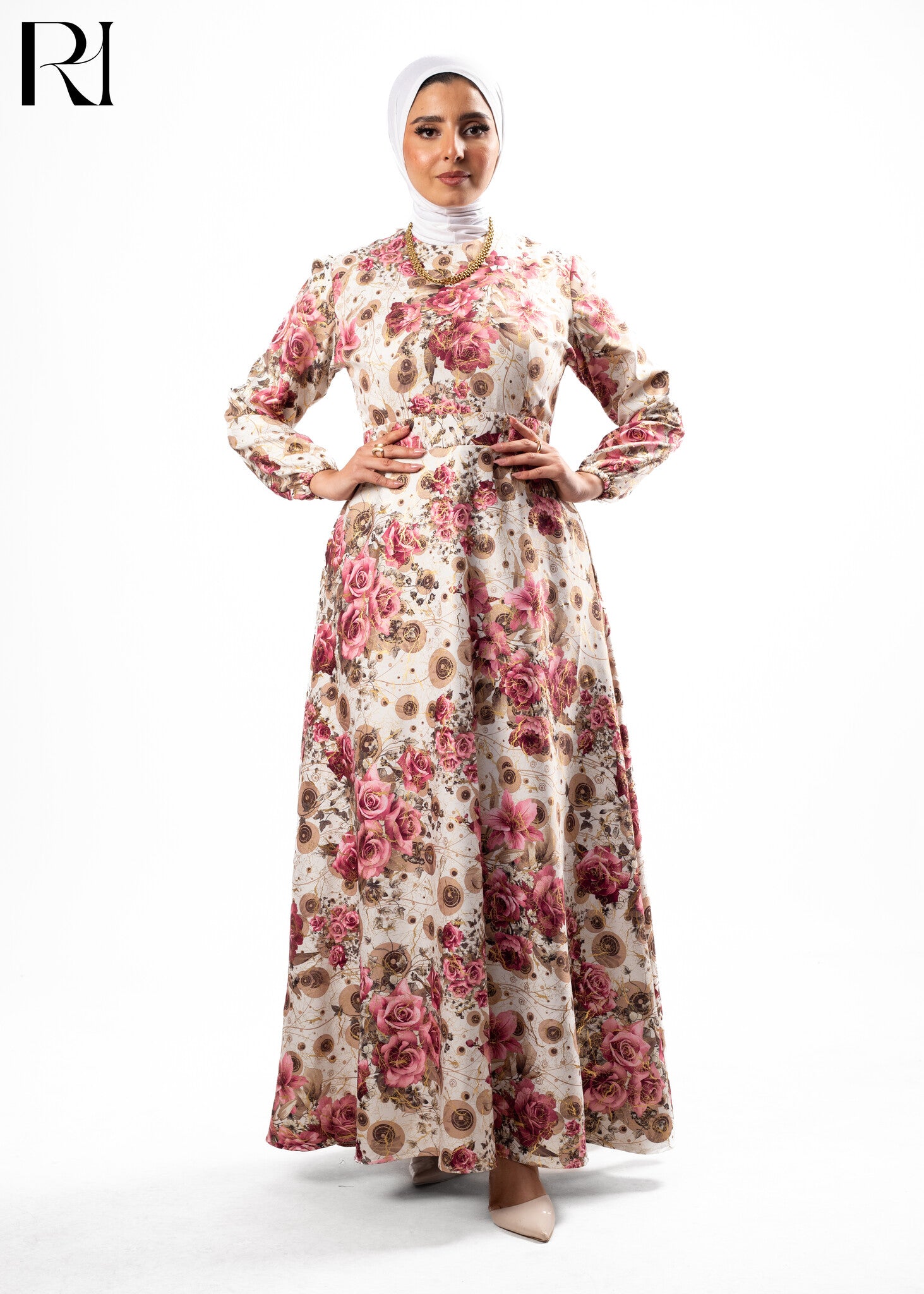 Woman wearing a floral dress with a hijab on a white background