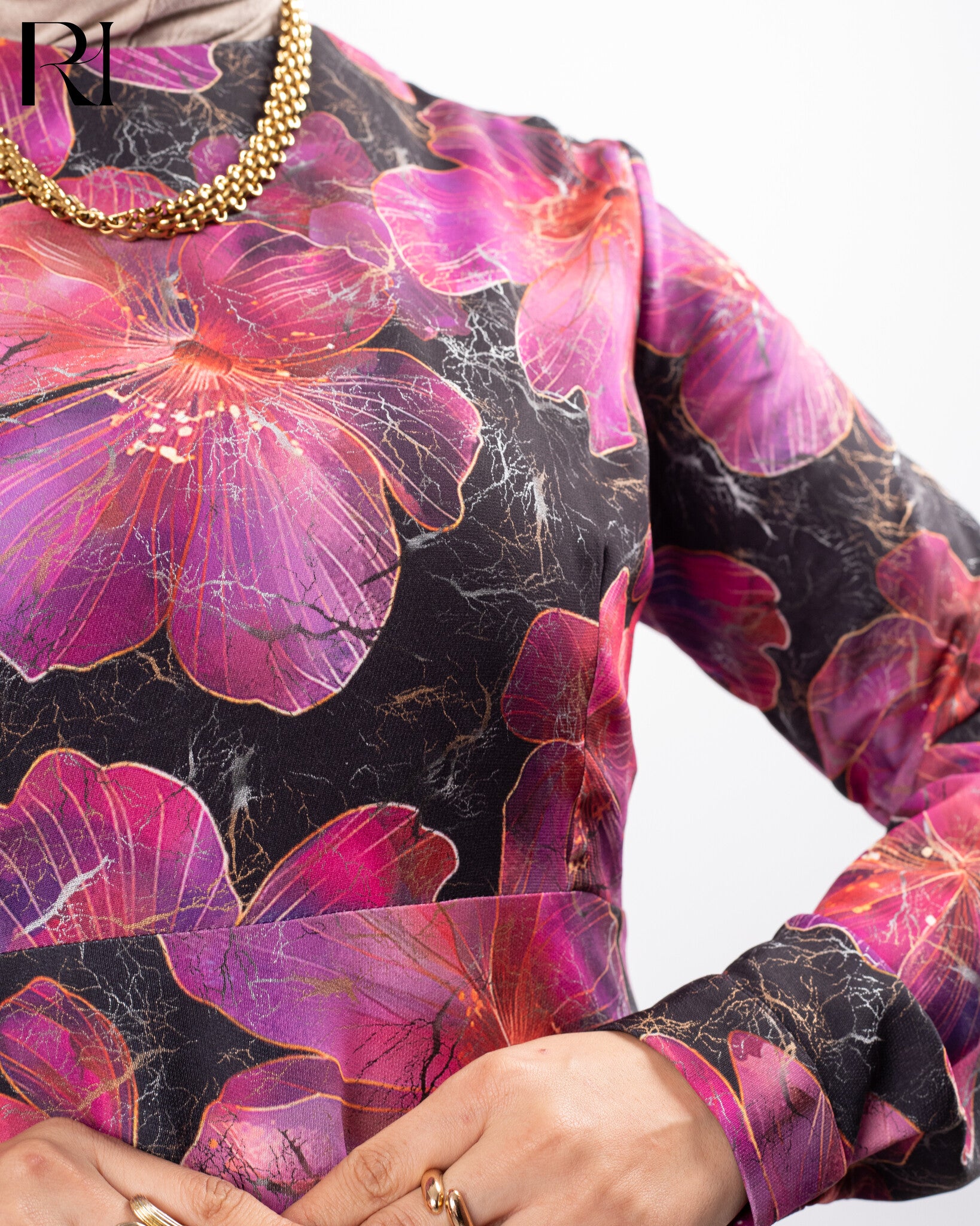 Close-up of a garment with pink floral pattern on a black background