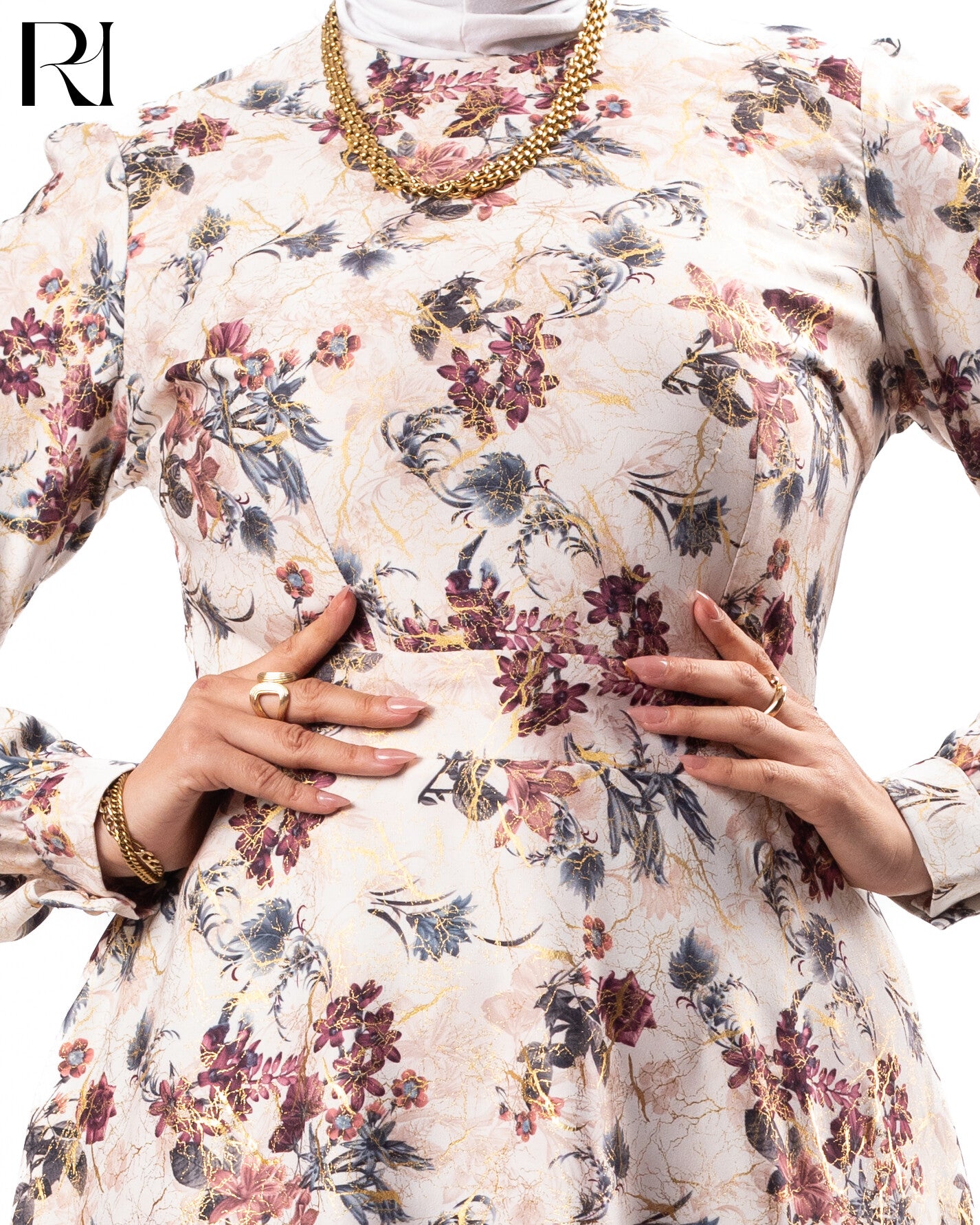 Floral dress with gold jewelry on a white background