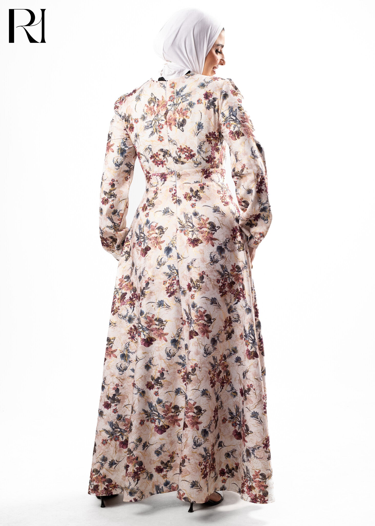 Woman wearing a floral dress with a hijab on a white background