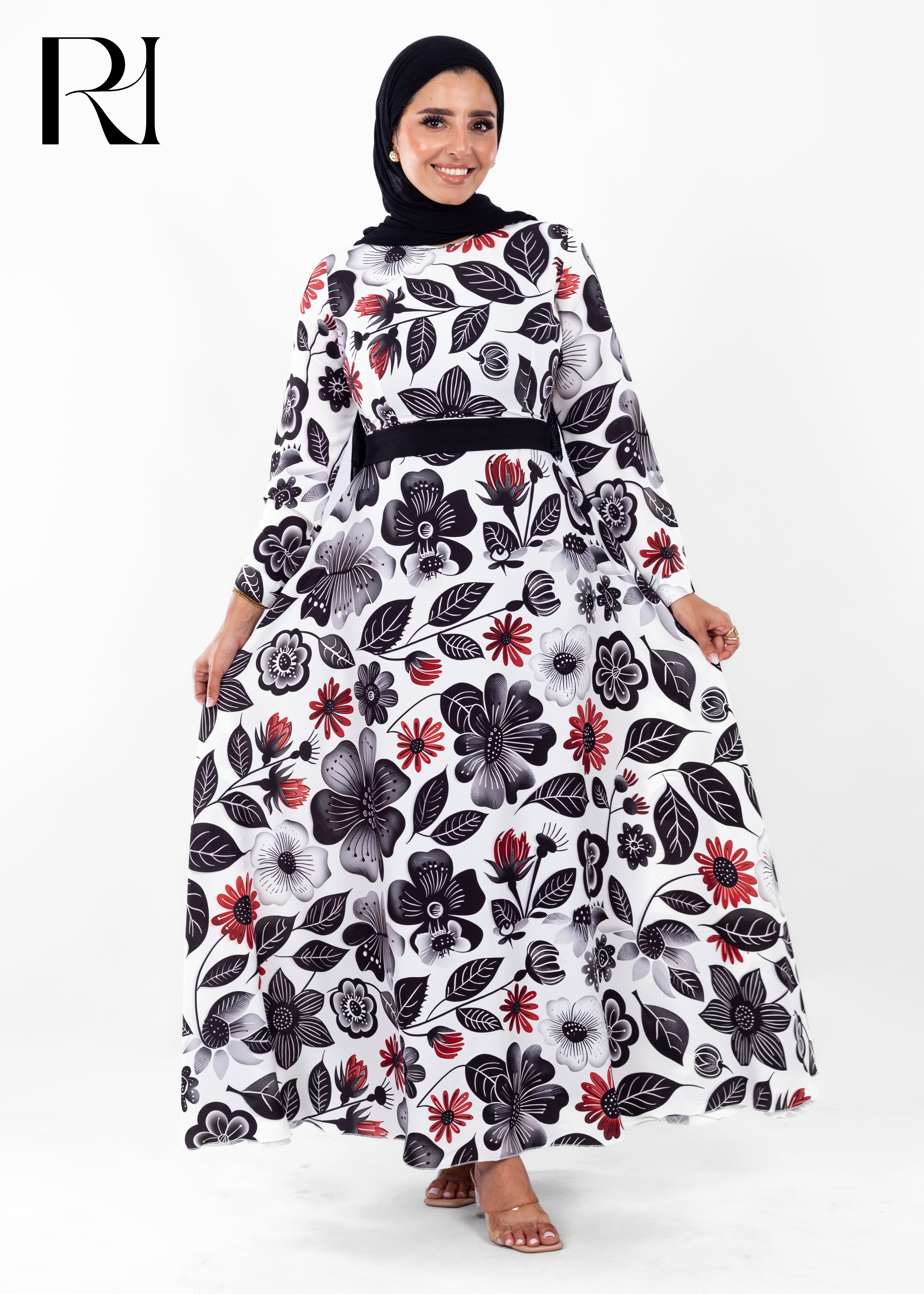 Woman wearing a floral dress with a black hijab on a white background