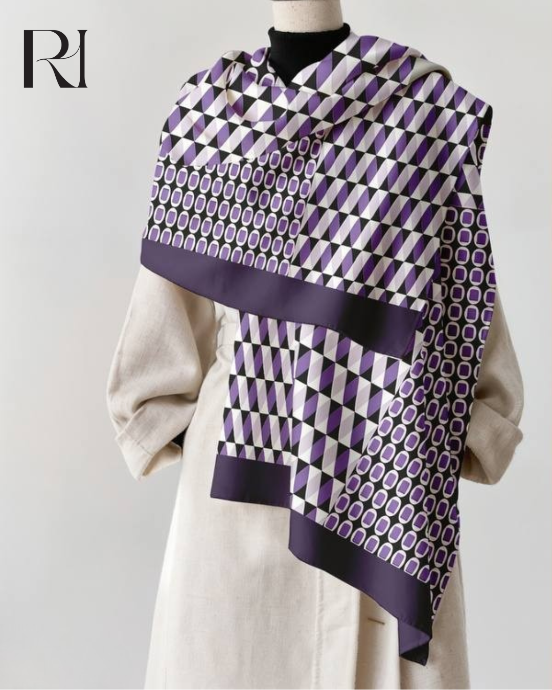 Person wearing a patterned scarf with a visible brand logo on a plain background