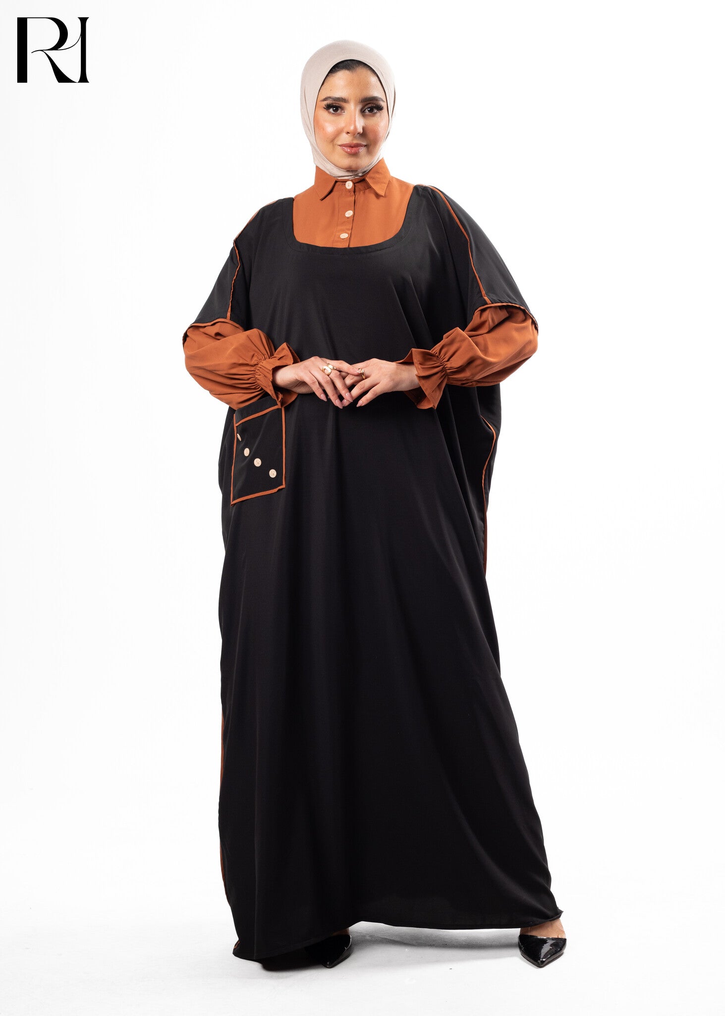 Woman wearing a black and brown dress with a hijab-ruehaya