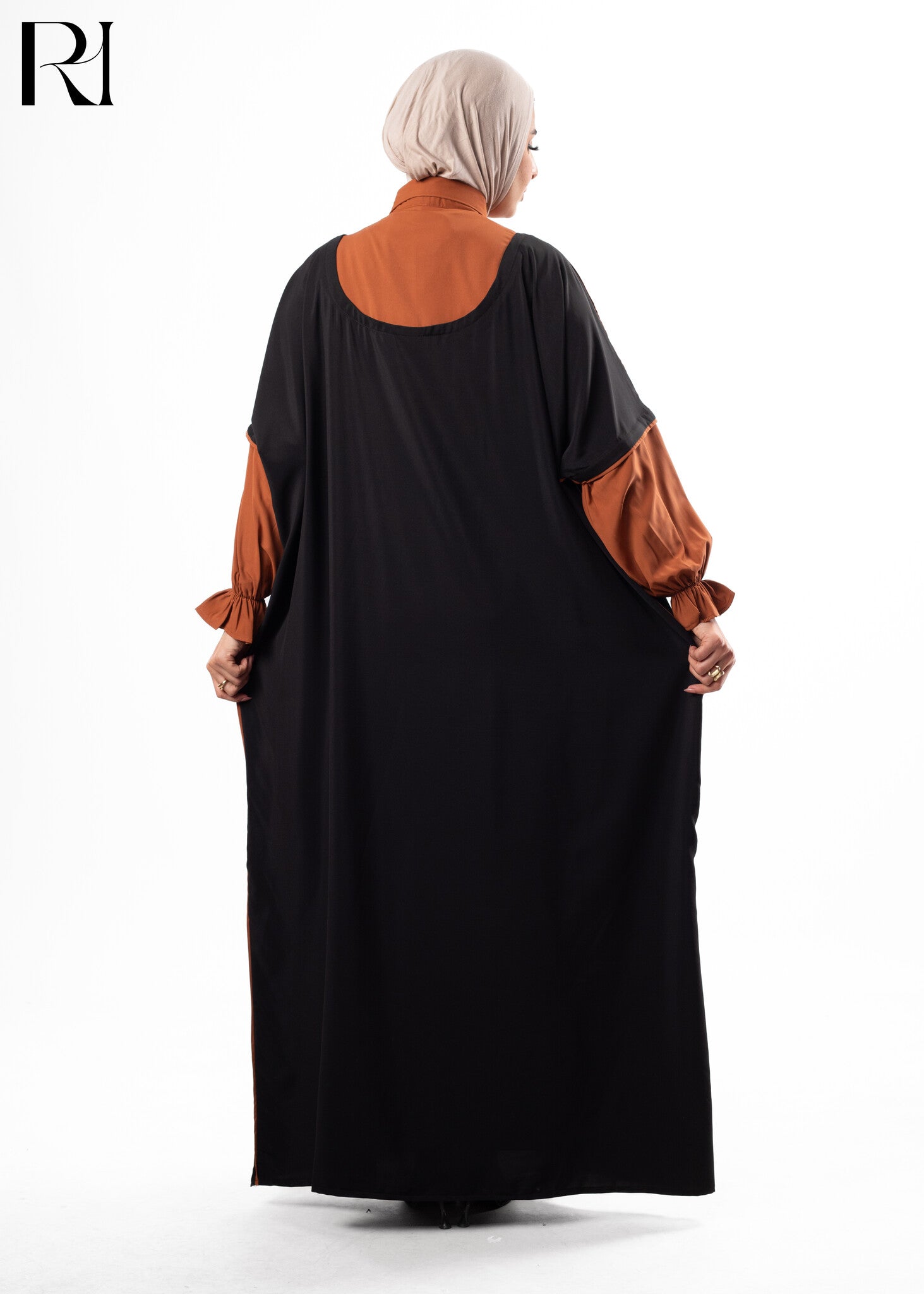 Woman wearing a black and brown dress with a hijab-ruehaya