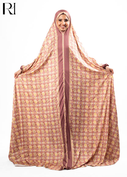 Woman wearing a patterned abaya with a hood on a white background, featuring the brand 'RI'.