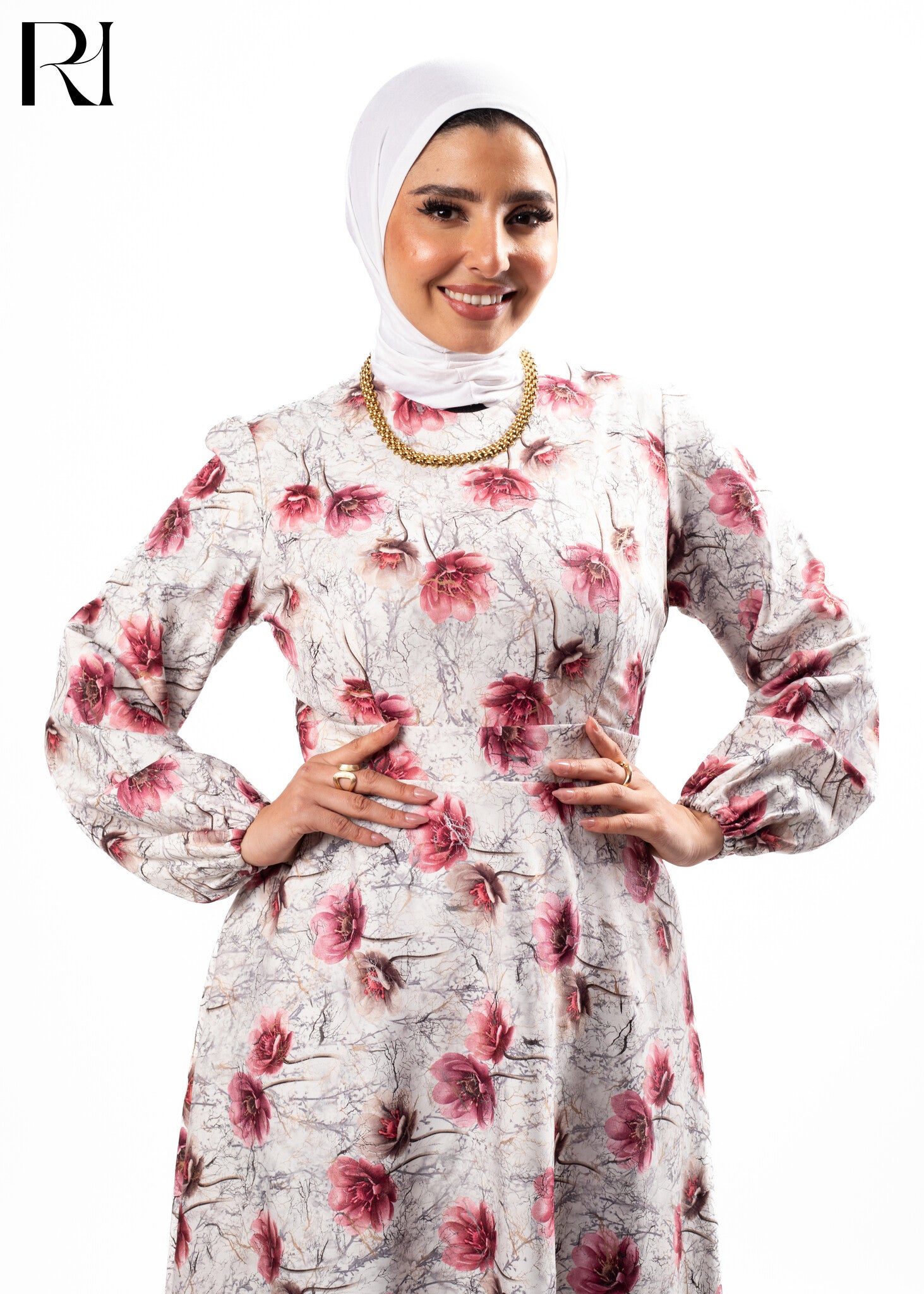 Woman wearing a floral dress with a hijab on a white background