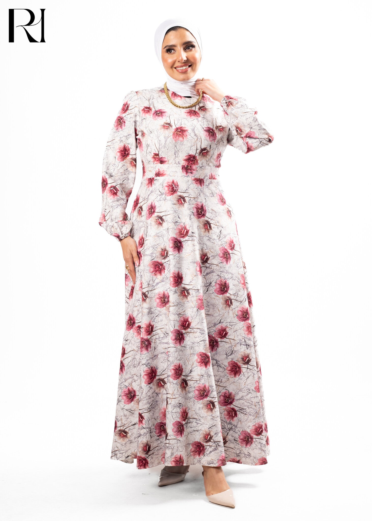 Woman wearing a floral dress with a hijab on a white background