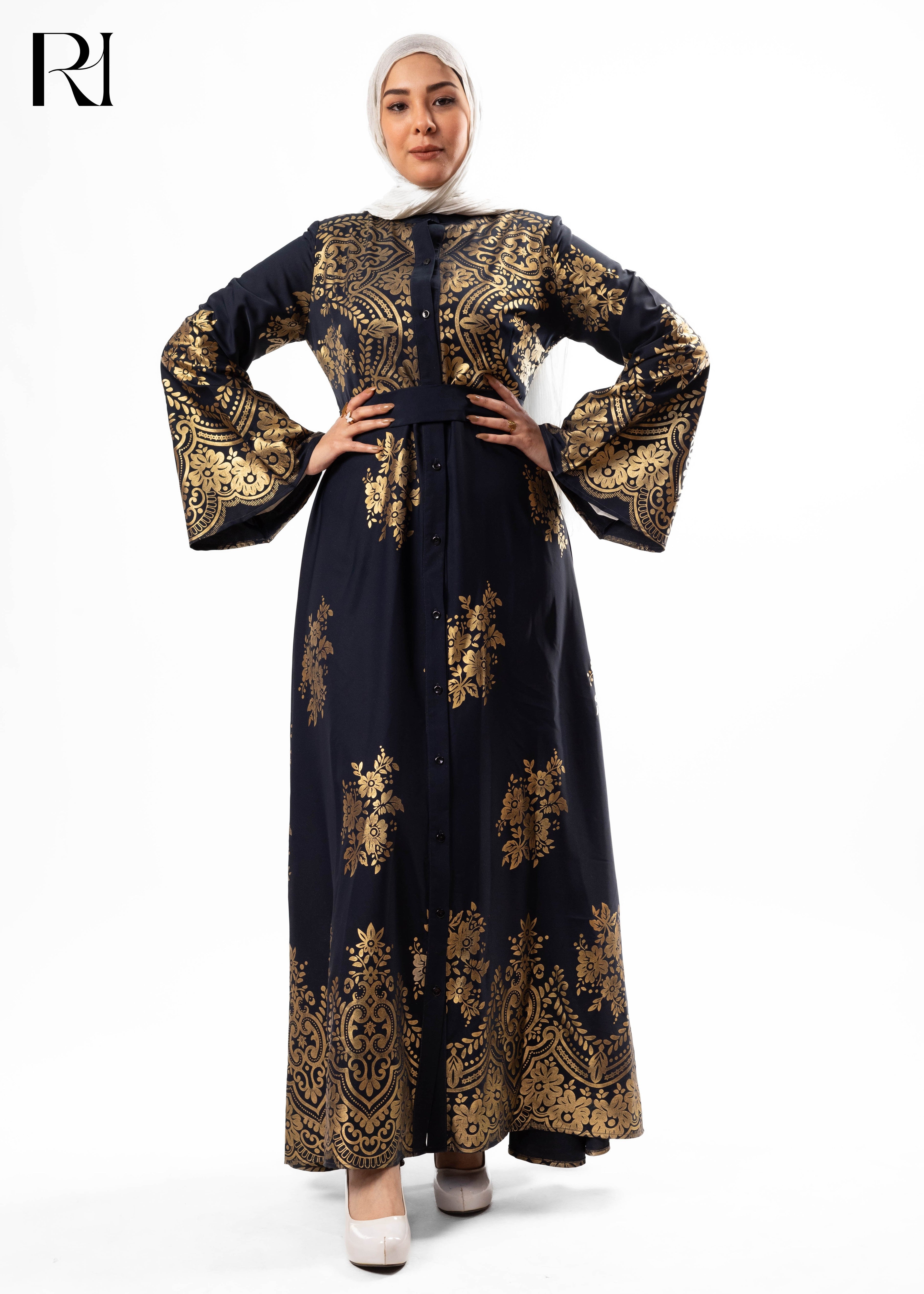 Woman wearing a black and gold embroidered dress on a white background