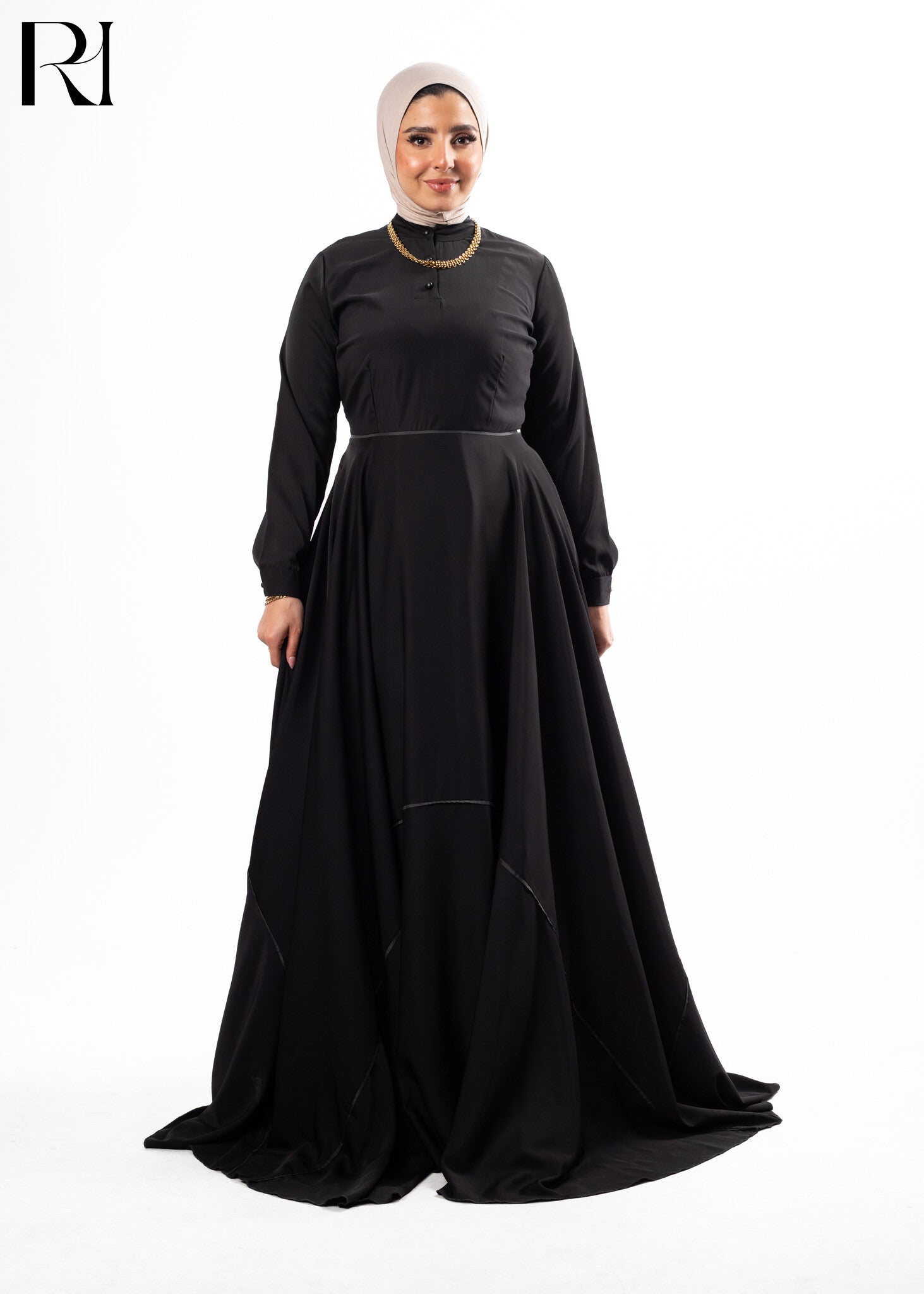 Woman wearing a black dress with a hijab-ruehaya