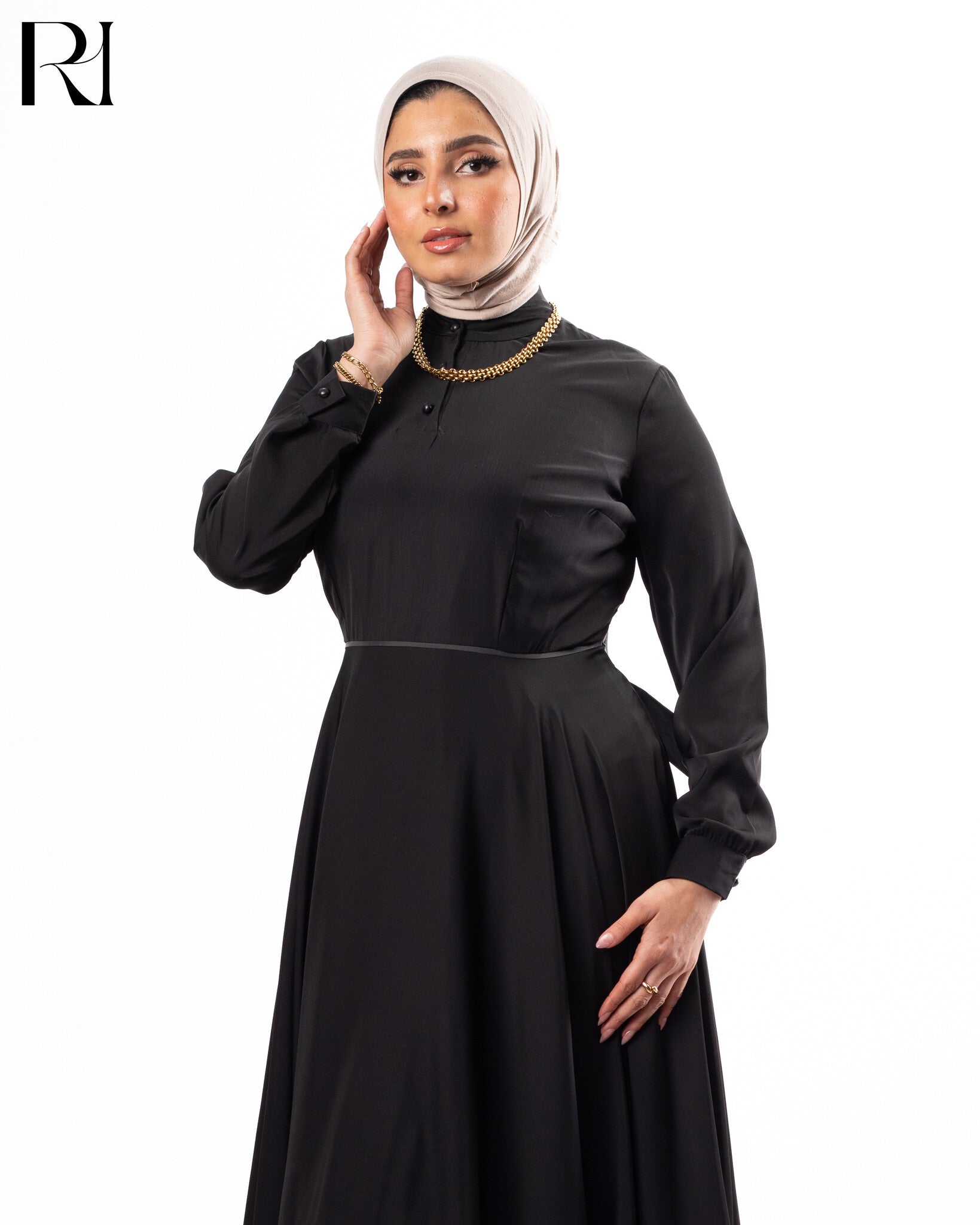 Woman wearing a black dress and beige hijab-ruehaya