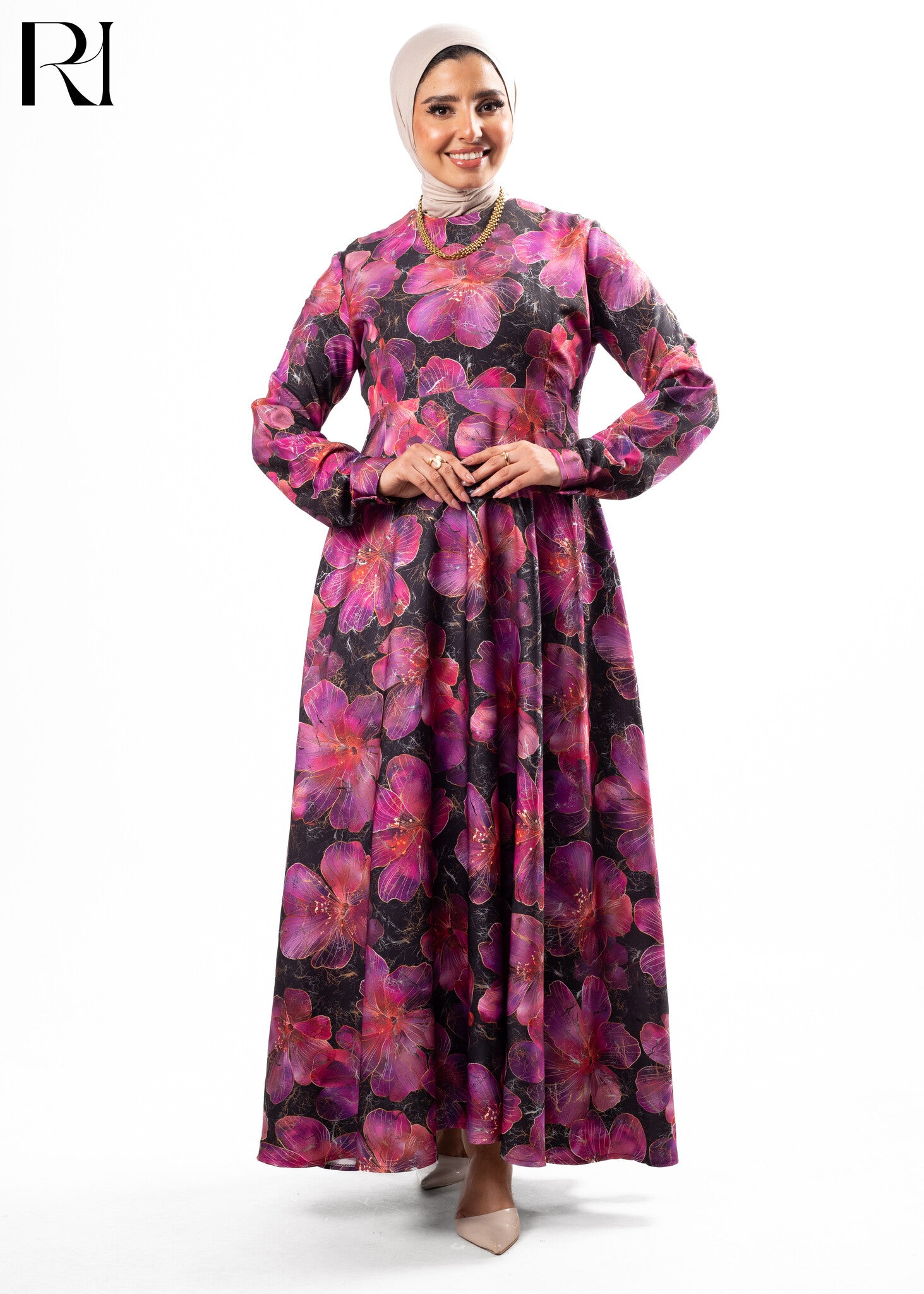 Woman wearing a long floral dress with a hijab on a white background