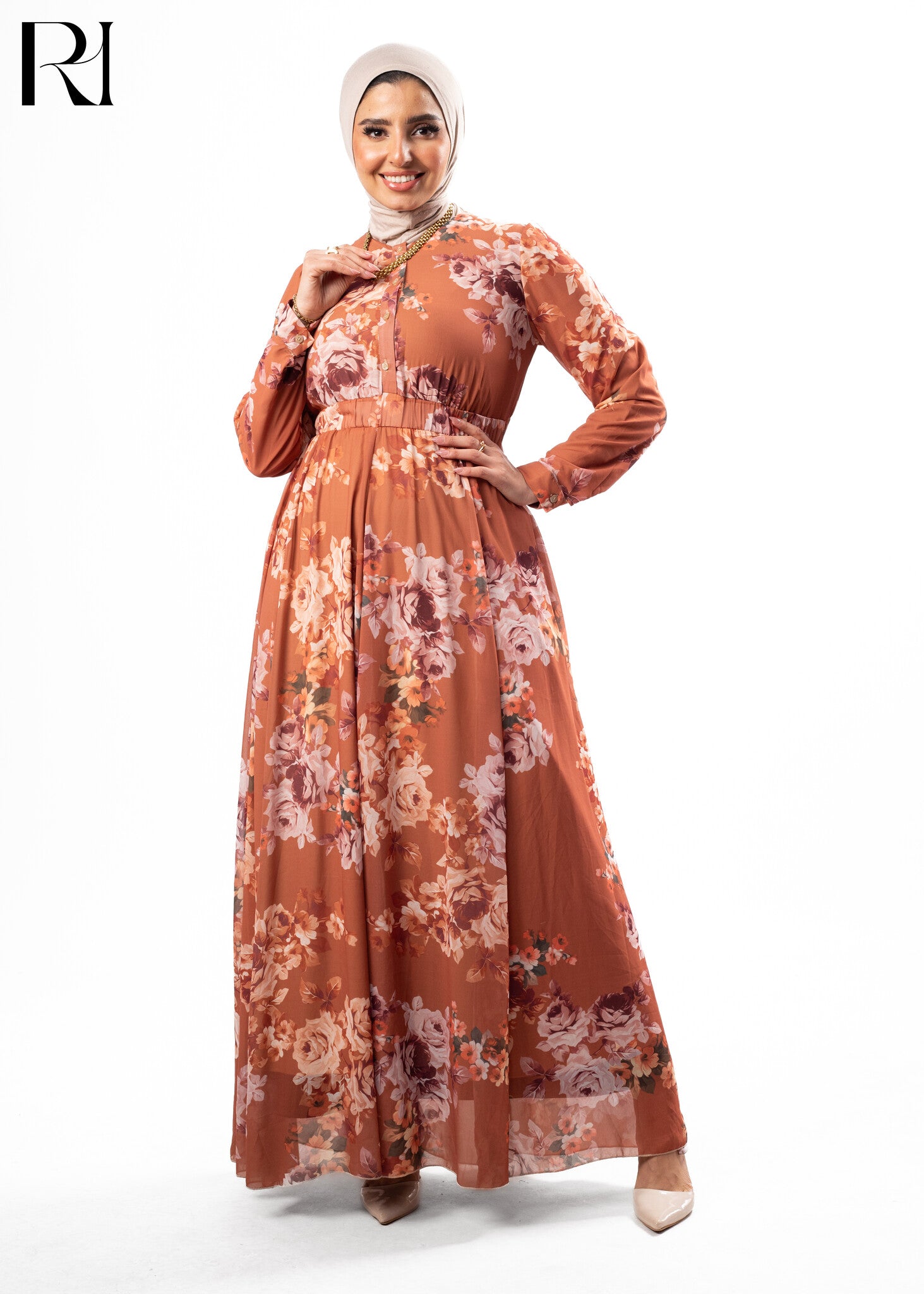 Woman wearing a floral dress with a hijab on a white background