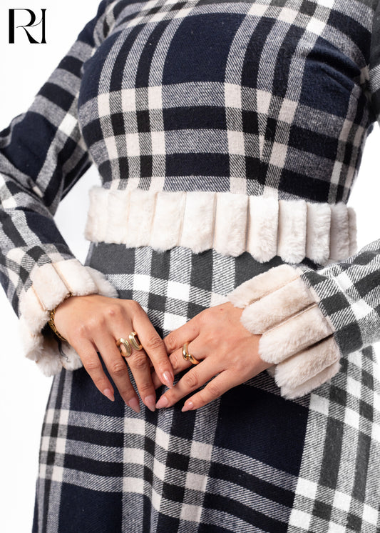 Navy and white checkered coat with fluffy white trim on a plain-ruehaya