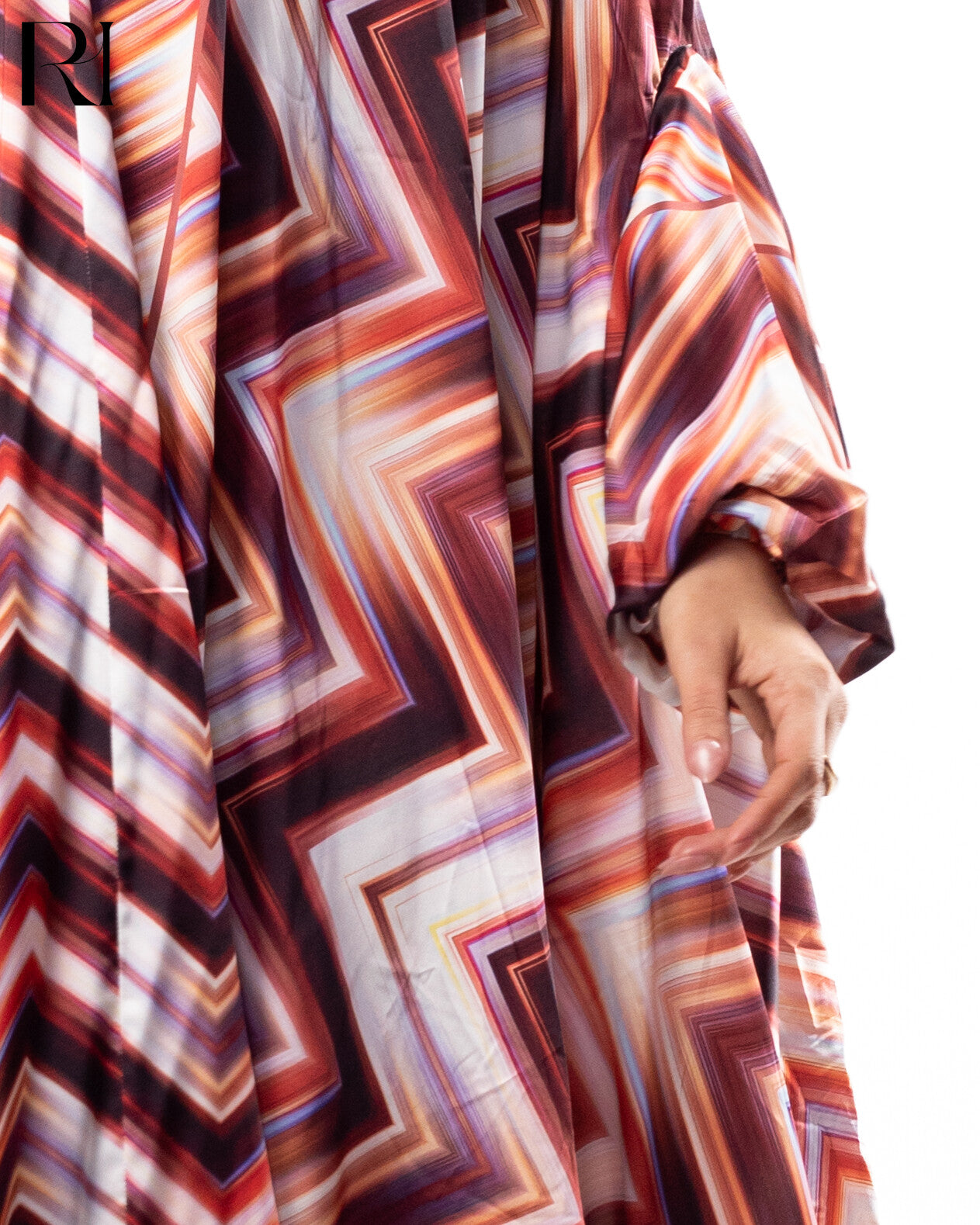 Close-up of a patterned garment with a visible brand logo.