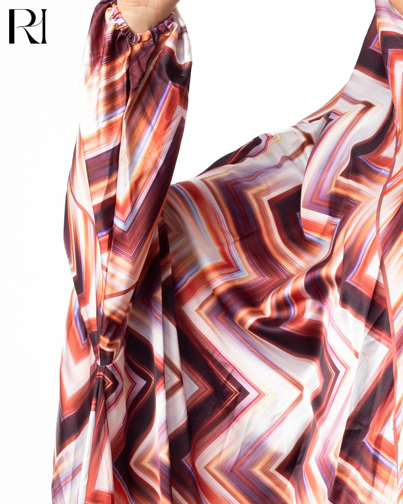 Colorful patterned pants with a brand logo on a white background